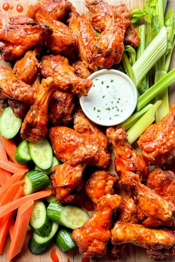 Crispy Baked Buffalo Wings and celery with a side of blue cheese dressing. 