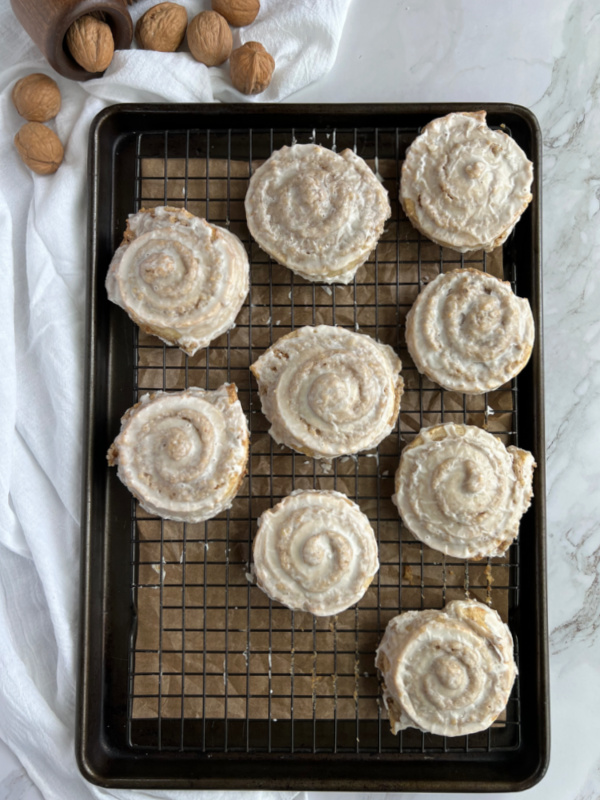 German Nut Rolls Nussschnecken on a baking sheet with some walnuts. 