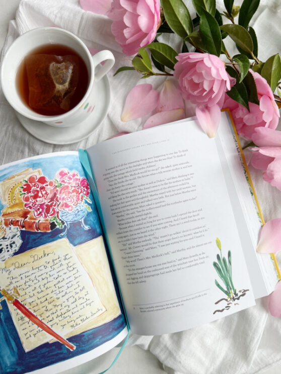 The Secret Garden Flatlay illustration Kate Lewis with pink camellia flowers and a white cup with polka dots filled with tea.