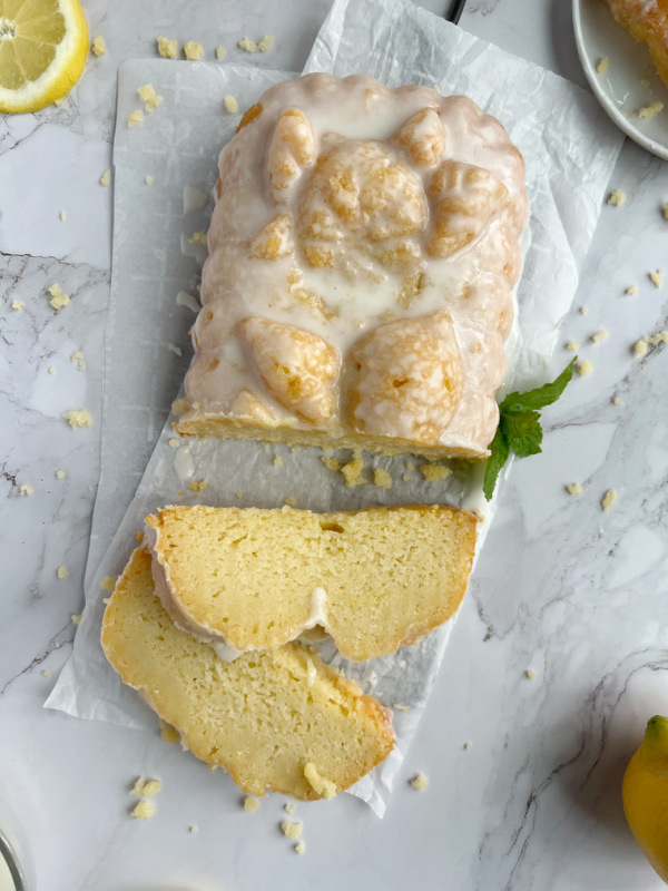 A lemon ricotta cake with 2 slices.