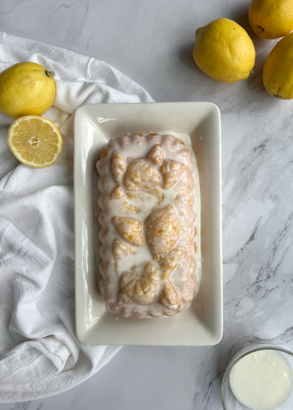 Ricotta Cake on a white plate with lemons.