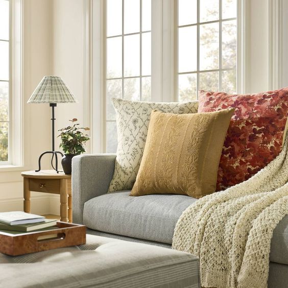 Target’s Studio McGee Fall 2024 Collection a living room couch piled high will fall pillows. 
