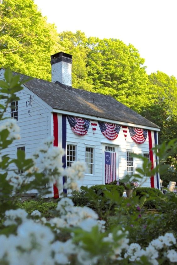 White New England House decorated for the 4th of July.