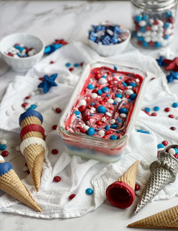 Patriotic Red White Blue no churn ice cream in a loaf pan with sugar cones.