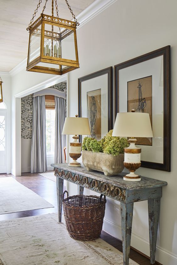 Ashley Gilbreath, foyer with table and two lamps and art.