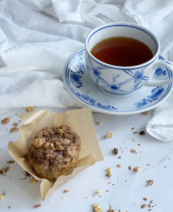 banana nut muffins with streusel and a blue and white chinoiserie cup of tea.