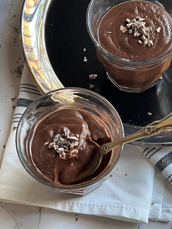 mocha chocolate pudding in a small glass with a spoon.