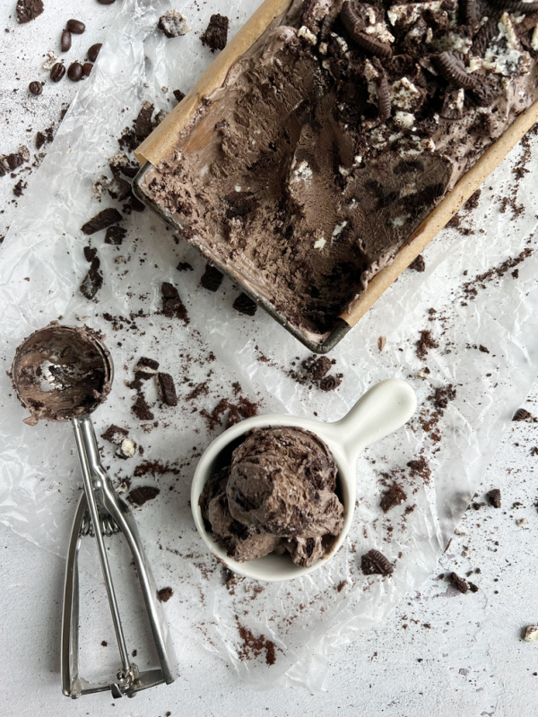 Chocolate Mocha cookies and cream ice cream in a small shite cup with a handle and in a loaf pan.