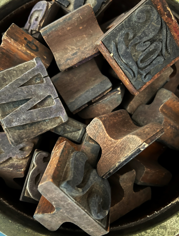 Letterpress blocks in a bowl.