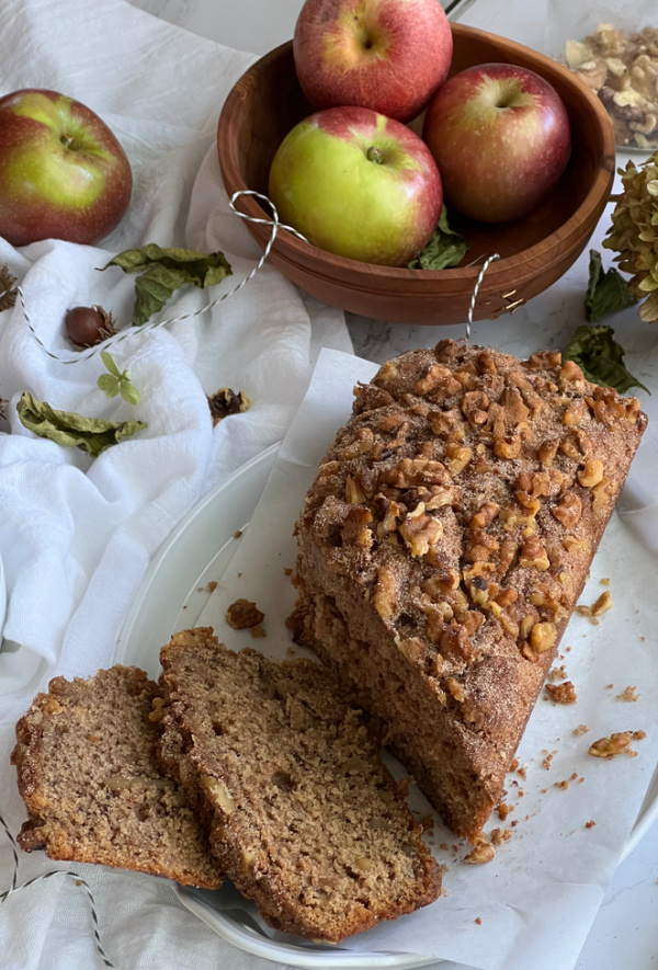 apple bread on a white platter sliced.