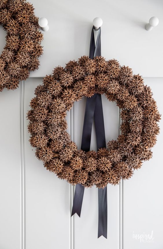 Sweet gum wreath Inspired by charm, 2 having on the wall with black ribbon.
