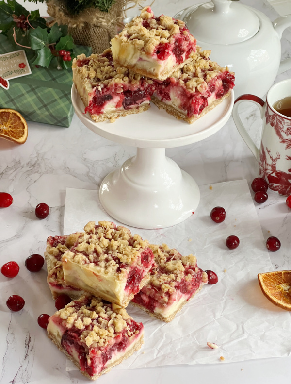 Cranberry Cheesecake bars on a white cake plate