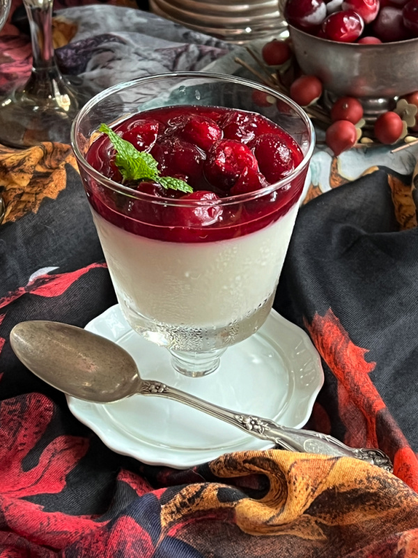 Cranberry panna cotta in a glass with a spoon
