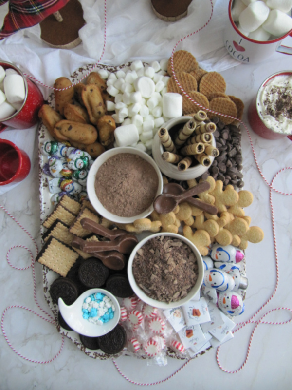 Hot chocolate board with marshmallows and cookies. 