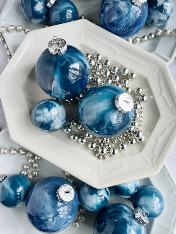 3 white ironstone platters with blue marble christmas ornaments