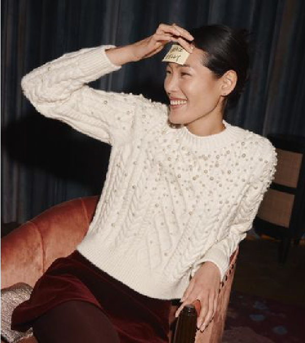 woman in white sweater and burgundy skirt