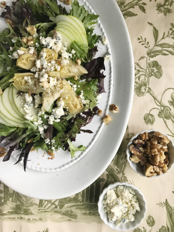 Artichoke salad on a white platter.