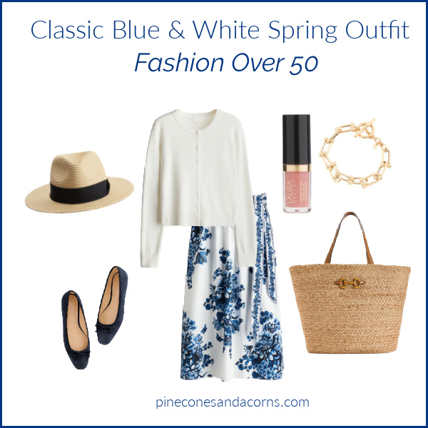 Blue and white Spring outfit Fashion over 50 with blue flower skirt, white sweater, straw bag, blue shoes and hat.