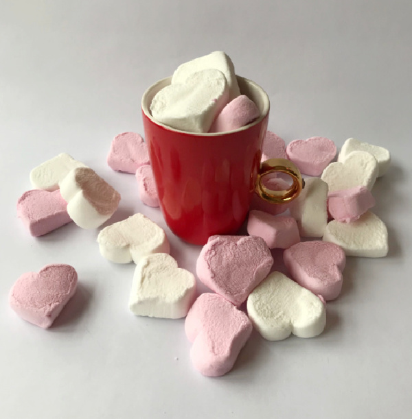 Red mug willed with pink and white marshmallows
