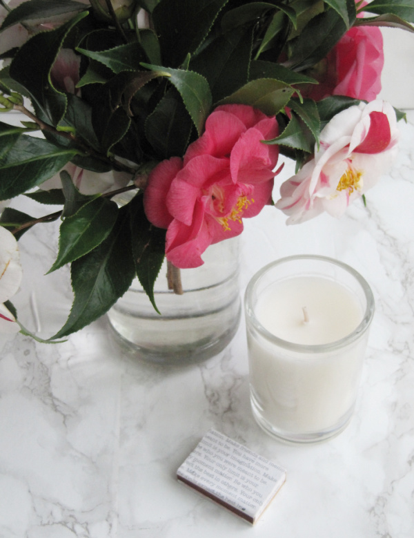 camellia flowers and a candle and matches