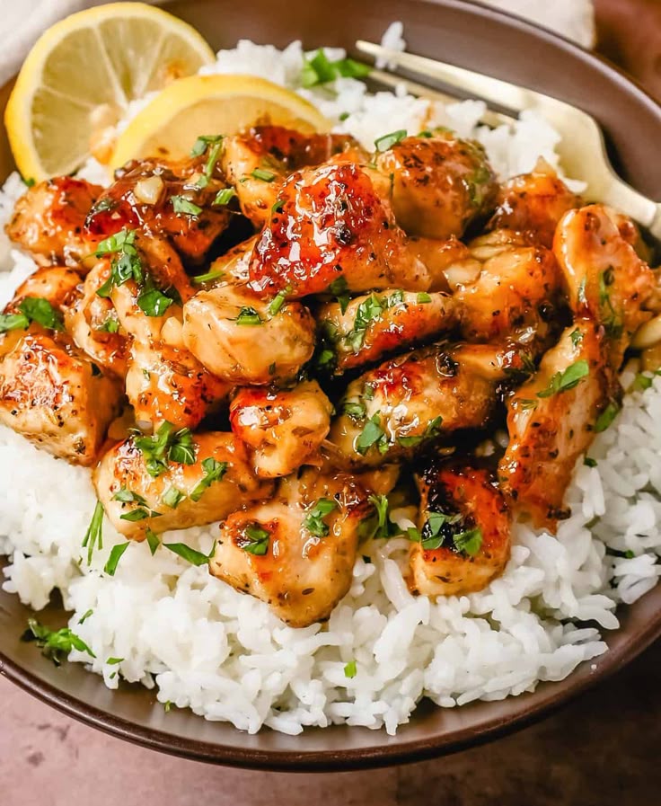 Honey Chicken over rice and lemon wedges. 