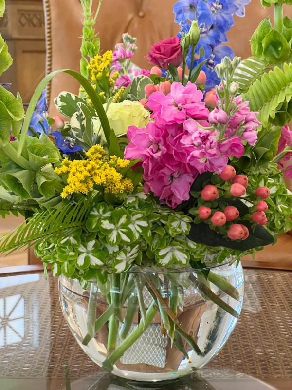 clear glass vase of colorful flowers.