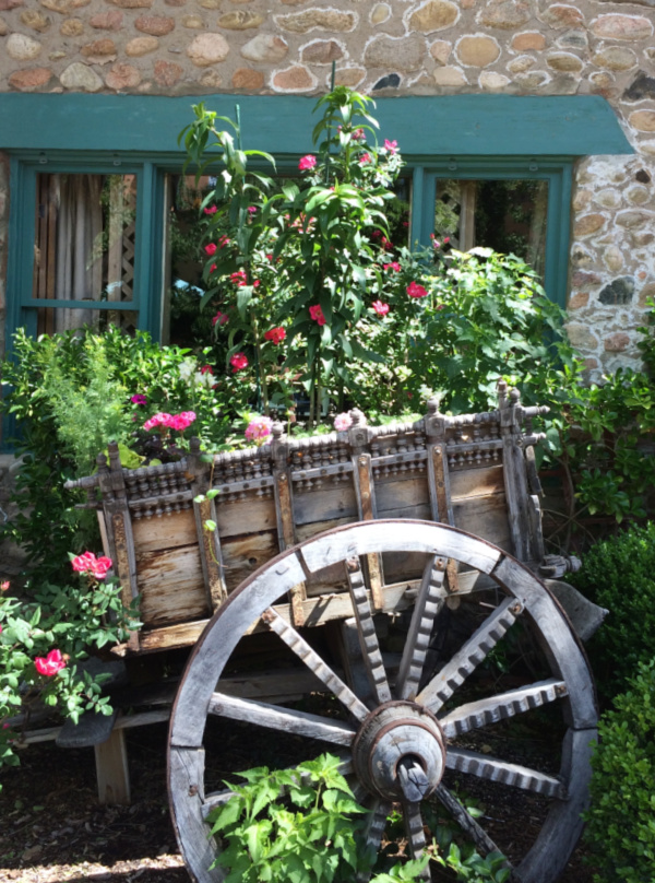 wood cart filled with flowers.