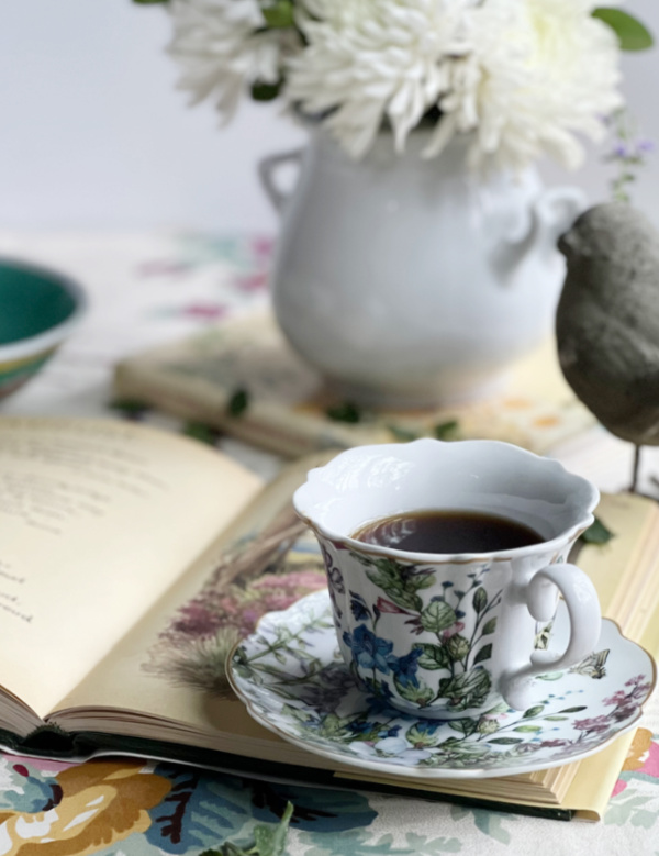 tea cup with flowers and a book.