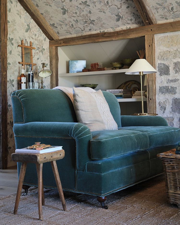 Patina Meadow Attic Apartment with a jade green velvet couch. 