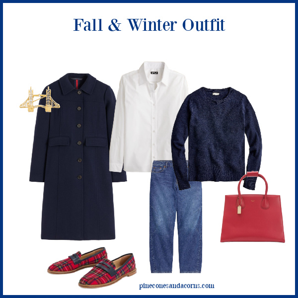 Fall outfit with blue coat, jeans, blue sweater, white blouse, red purse and plaid loafers.