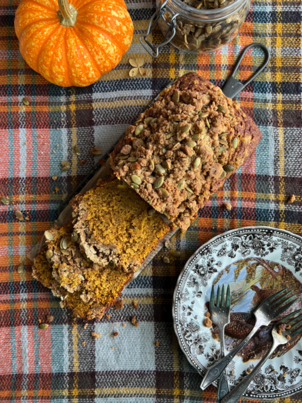 Pumpkin Spice Bread with Pepita Streusel Topping, an orange pumpkin and plates with forks.