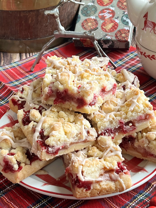 closeup of pear cranberry crumb bars and a small silver deer ornament.
