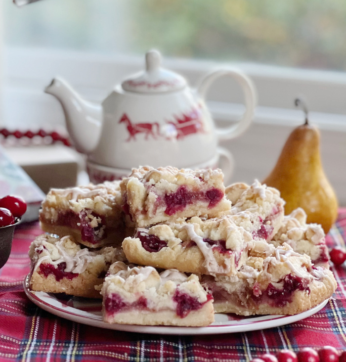 cranberry pear crumble bars with a pear and a teapot.