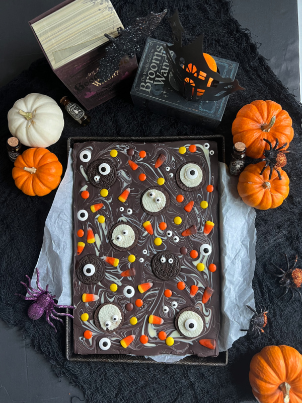 halloween chocolate bark with spooky books, pumpkins and spiders.
