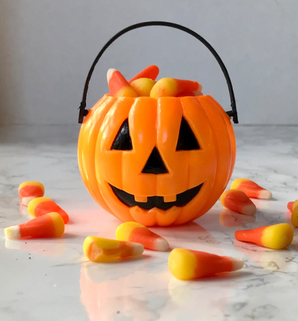small jack o lantern filled with candy corns.