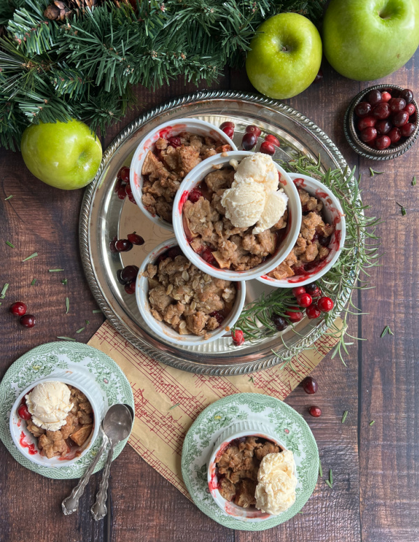 Cranberry Apple crisp with ice cream in white ramekins.
