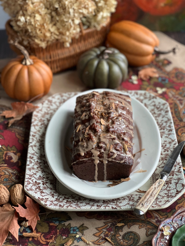 pumpkin banana bread on brown transfer ware plates.